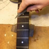 Smoothing fret ends after securing loose frets&nbsp;&copy;&nbsp;2026&nbsp;Guitar Angel